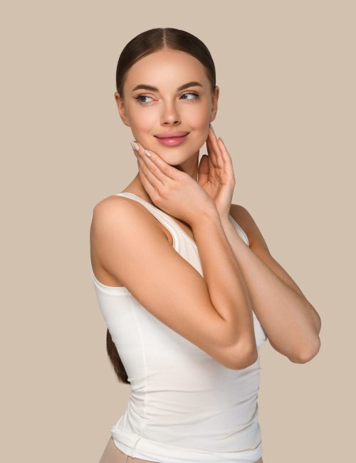 Beauty healthy skin women touching face cosmetic studio portrait. Sportswear color background brown